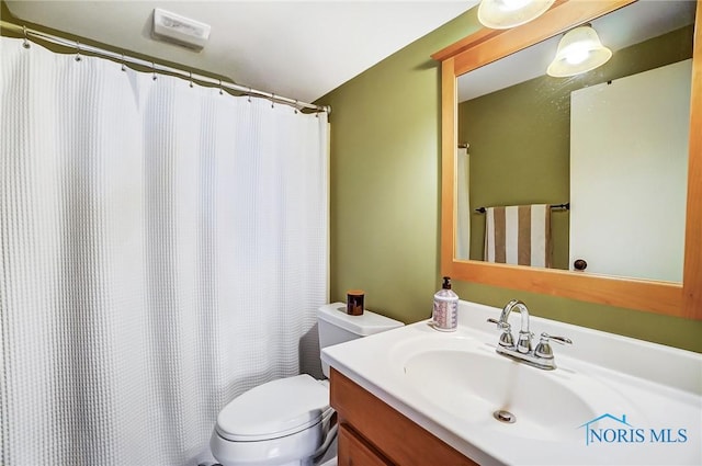 bathroom featuring toilet and vanity