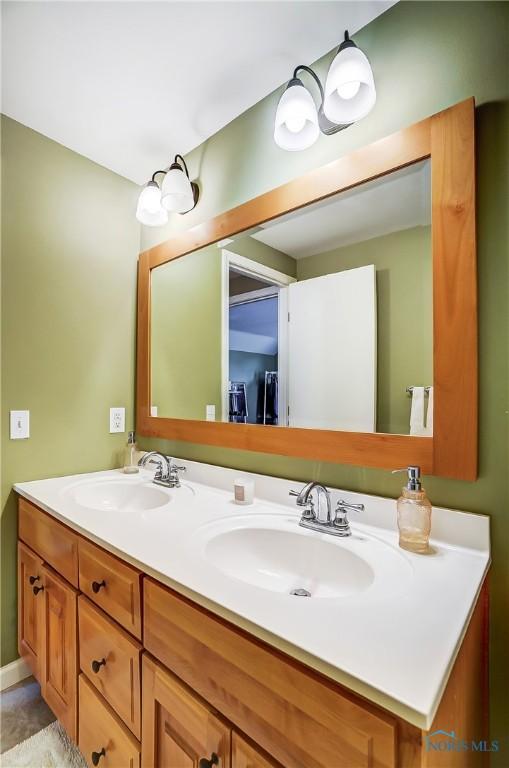 bathroom featuring a sink and double vanity