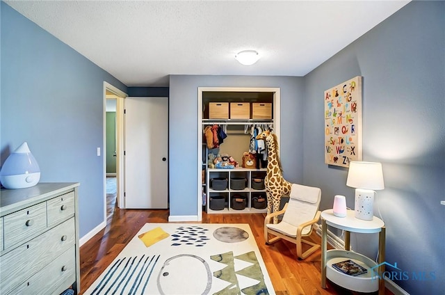 sitting room featuring wood finished floors and baseboards