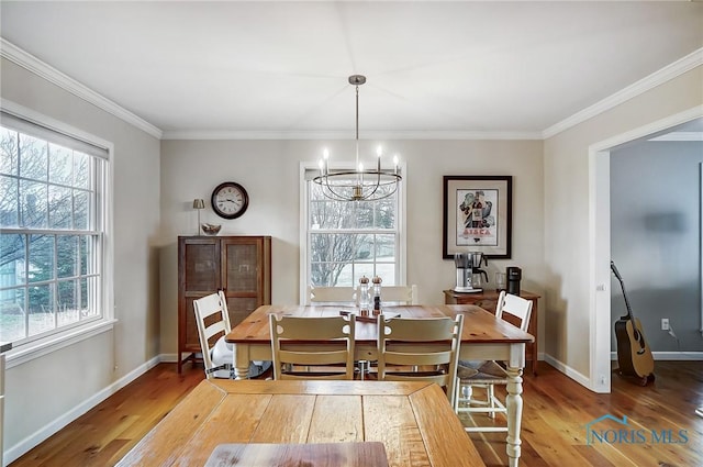 dining space featuring plenty of natural light, wood finished floors, and a chandelier