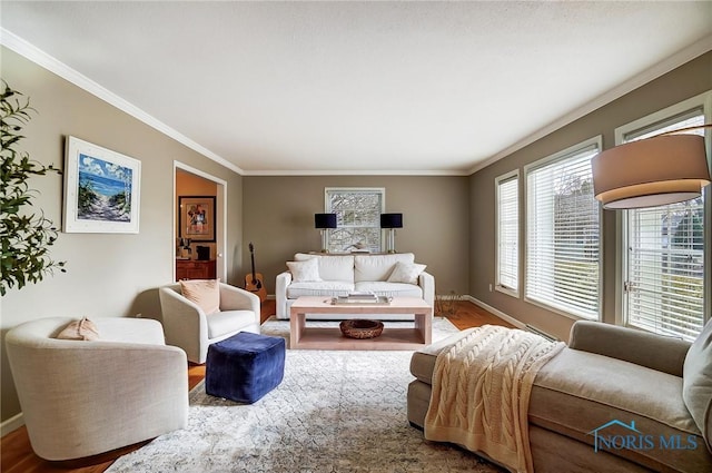 living area with crown molding, baseboards, and wood finished floors