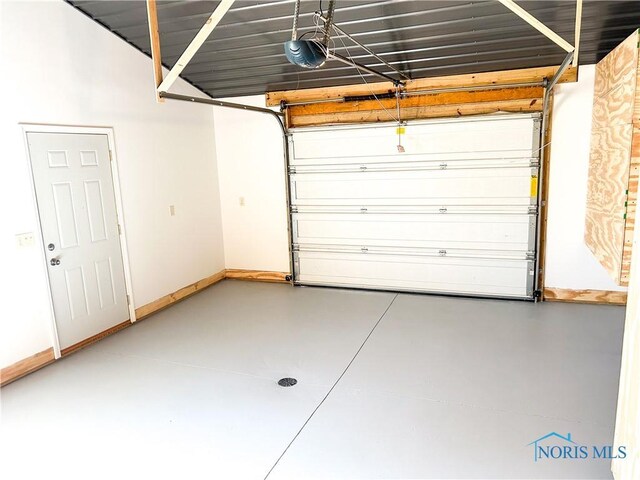 garage with a garage door opener and baseboards