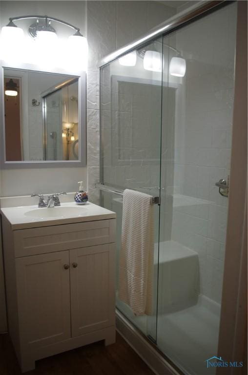 full bathroom featuring vanity and a shower stall