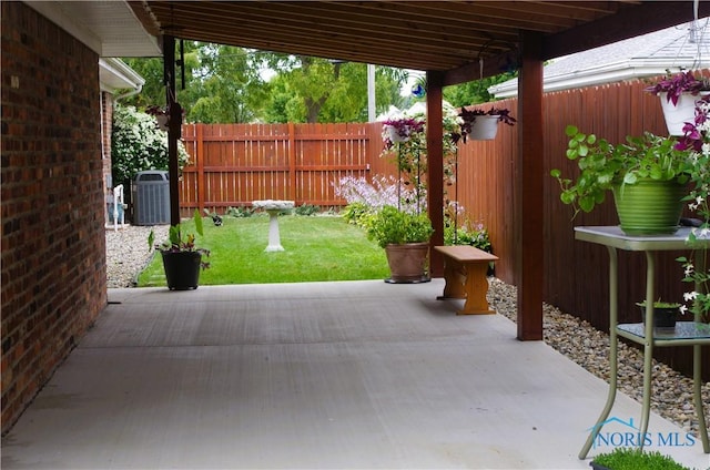 view of patio / terrace featuring fence and central AC