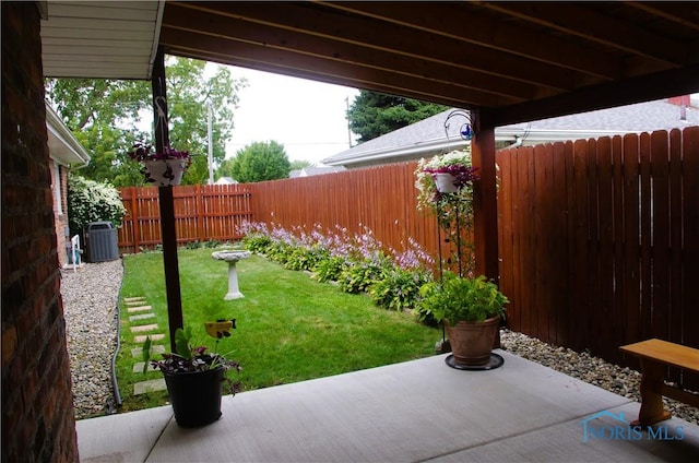 view of yard featuring a patio, central AC, and a fenced backyard