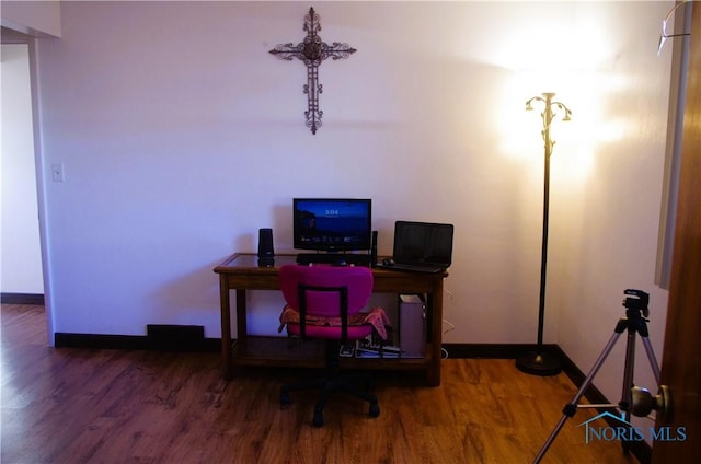 home office with baseboards and wood finished floors