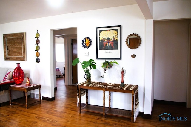 hall with wood finished floors and baseboards