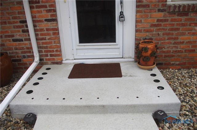 property entrance featuring brick siding