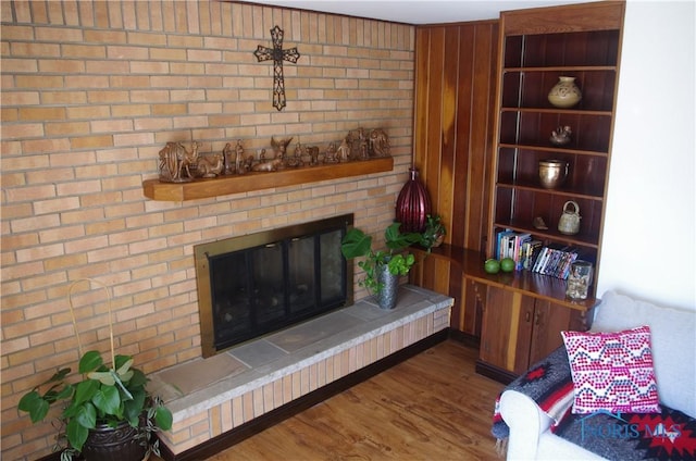 living area featuring wood finished floors and a fireplace