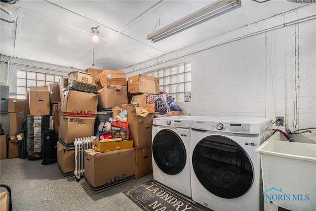 washroom with a garage, plenty of natural light, separate washer and dryer, and laundry area