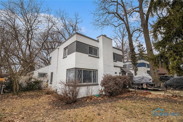 view of side of property with fence