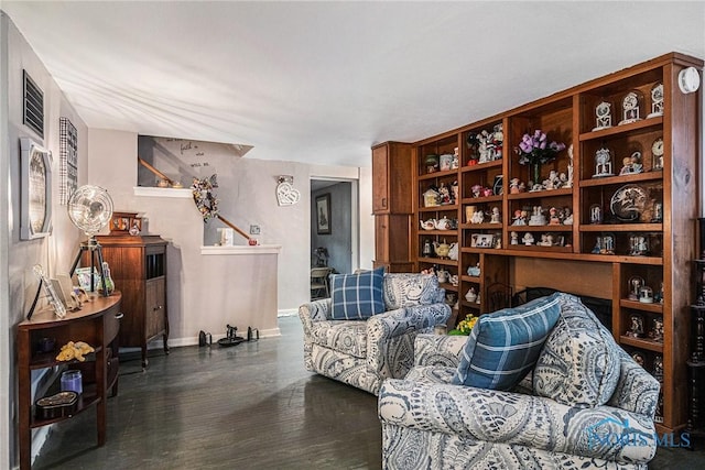 living area with baseboards and wood finished floors