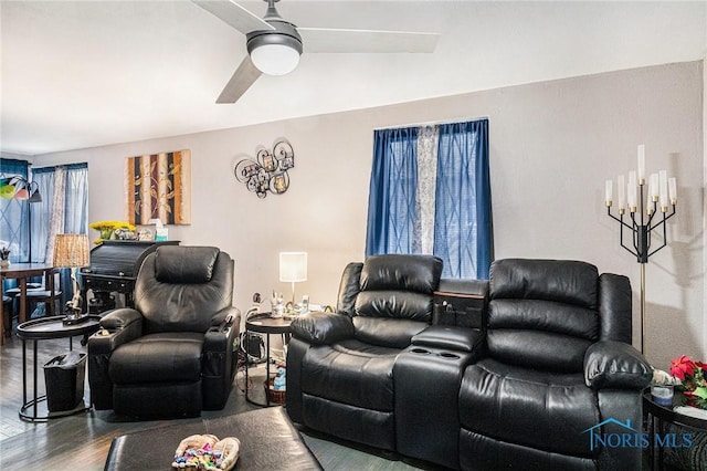 living area with wood finished floors and a ceiling fan