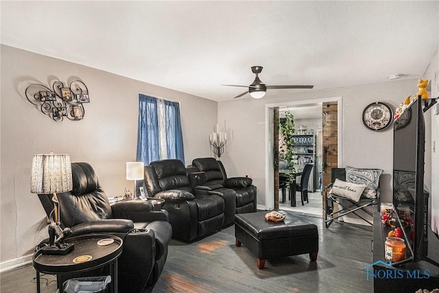 living room with baseboards, a ceiling fan, and wood finished floors