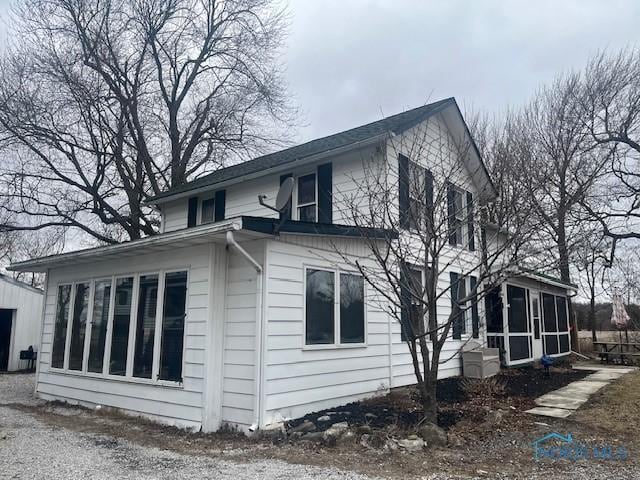 view of side of property with a sunroom