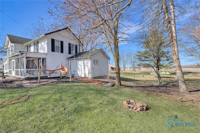 10243 S Dixie Hwy, Portage, OH 43451 - exterior space featuring a fire pit, a sunroom, fence, and a lawn