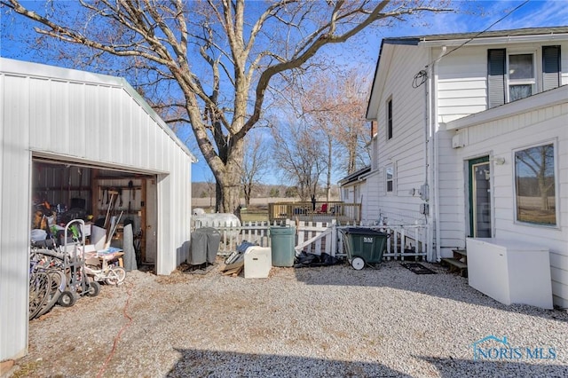 10243 S Dixie Hwy, Portage, OH 43451 - view of home's exterior with a garage, fence, and an outbuilding