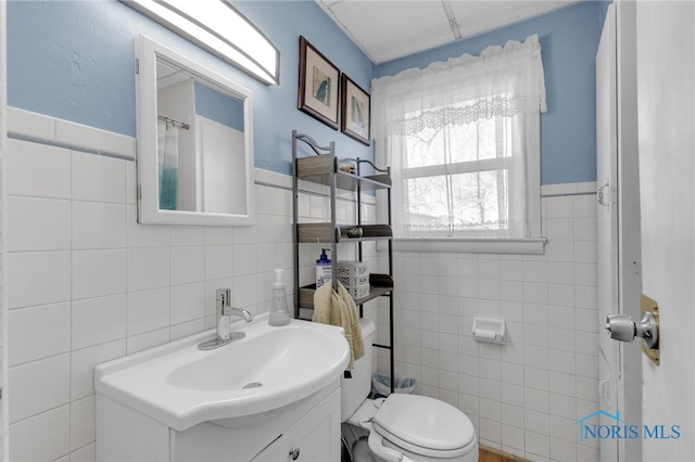 10243 S Dixie Hwy, Portage, OH 43451 - bathroom with toilet, vanity, and tile walls