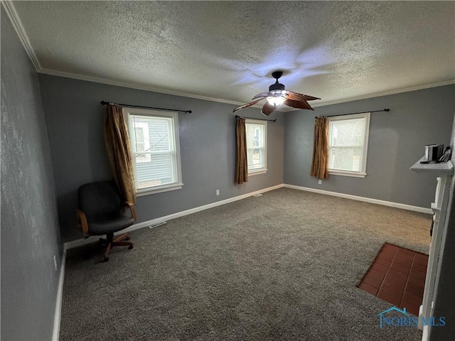 unfurnished room with baseboards, carpet floors, ceiling fan, ornamental molding, and a textured ceiling