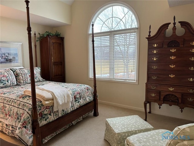 bedroom with multiple windows, baseboards, and light carpet