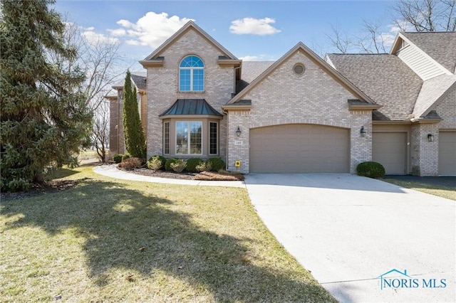 view of front of property featuring brick siding, a shingled roof, a front lawn, driveway, and an attached garage