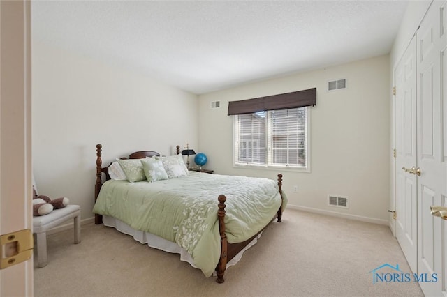 bedroom featuring baseboards, visible vents, and light carpet