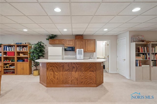 kitchen featuring light carpet, freestanding refrigerator, recessed lighting, black microwave, and light countertops