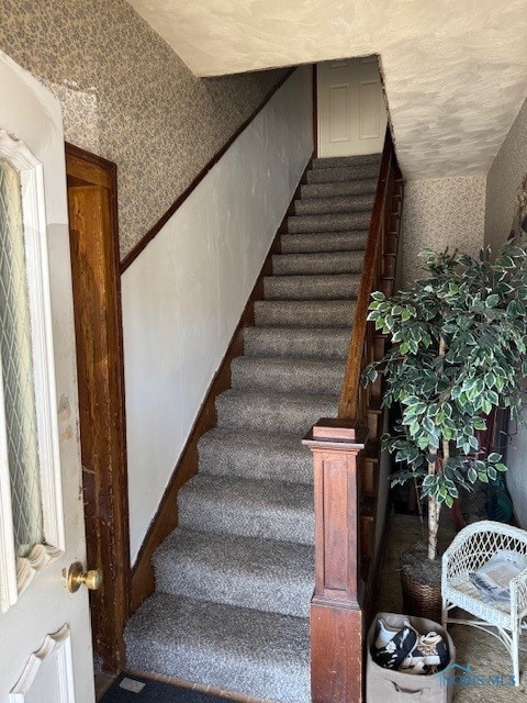 stairway with wallpapered walls