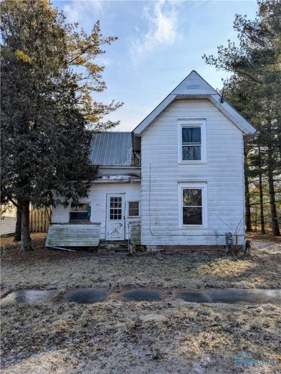 back of house with metal roof