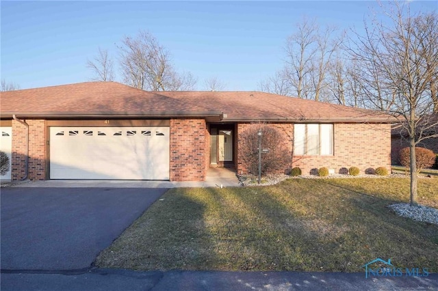 ranch-style house with aphalt driveway, brick siding, roof with shingles, and an attached garage