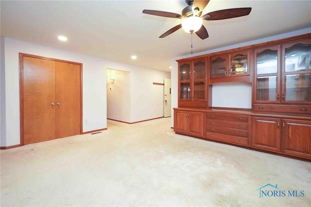 empty room featuring recessed lighting, light colored carpet, a ceiling fan, and baseboards