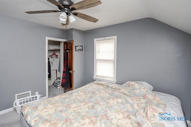 carpeted bedroom with baseboards, visible vents, ceiling fan, vaulted ceiling, and a closet