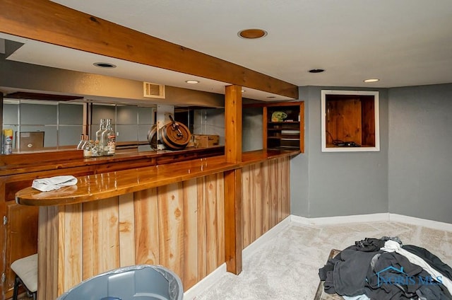 bar with visible vents, baseboards, beamed ceiling, carpet flooring, and a bar