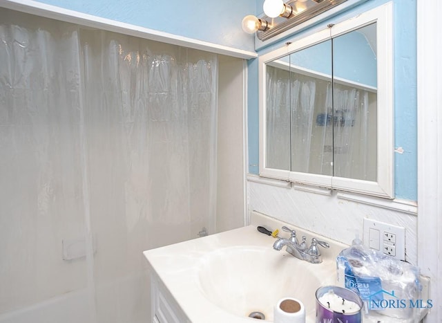 bathroom with vanity and a bath