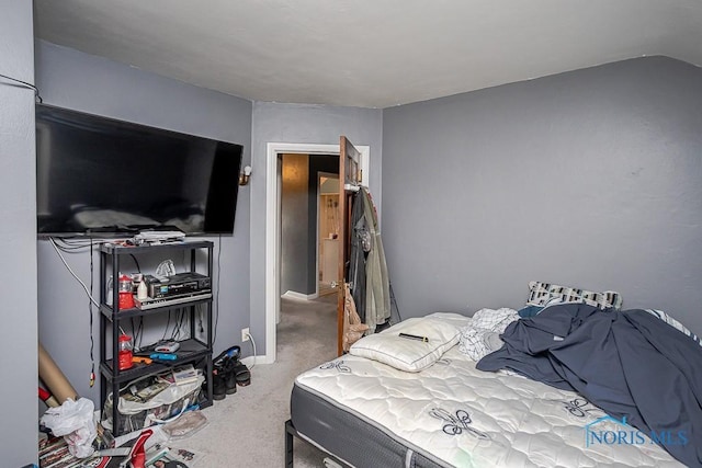 carpeted bedroom featuring lofted ceiling