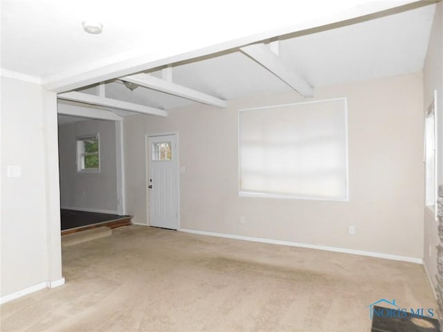 unfurnished room featuring beamed ceiling, baseboards, and carpet floors