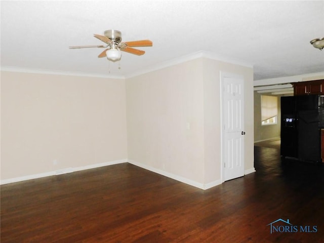 spare room featuring dark wood-type flooring, crown molding, baseboards, and ceiling fan