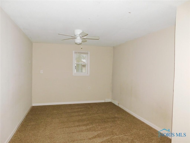 spare room with baseboards, carpet, and ceiling fan