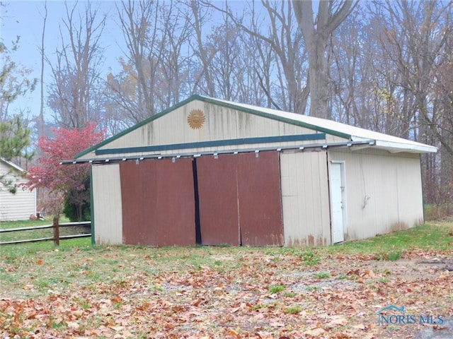 view of pole building with fence