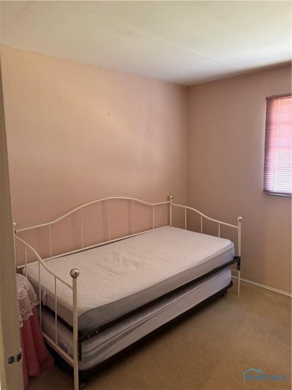 unfurnished bedroom featuring baseboards and carpet floors