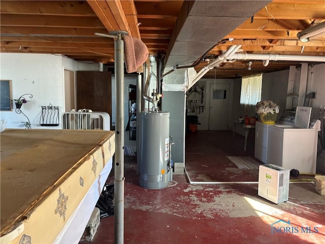 unfinished basement with gas water heater and washing machine and clothes dryer