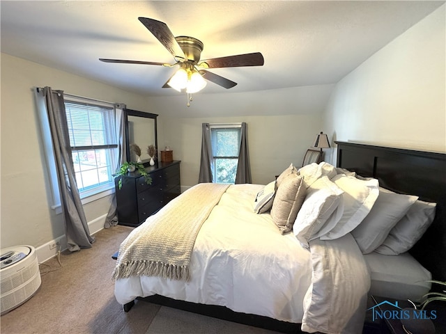 carpeted bedroom with baseboards, a ceiling fan, and vaulted ceiling