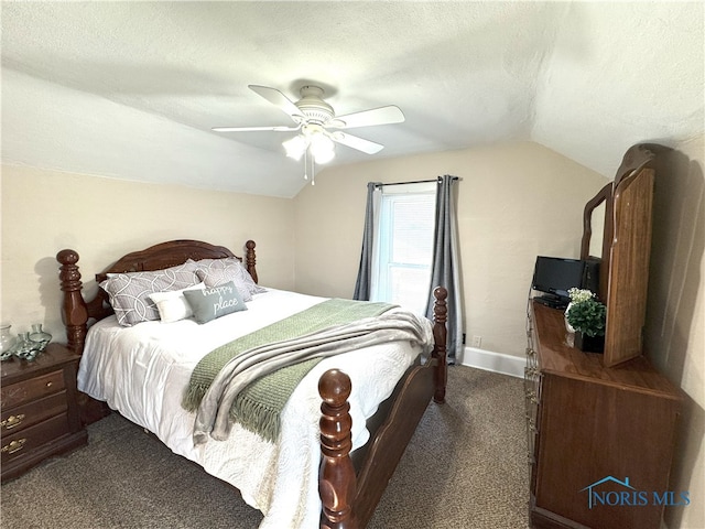 bedroom with a ceiling fan, a textured ceiling, dark carpet, baseboards, and lofted ceiling