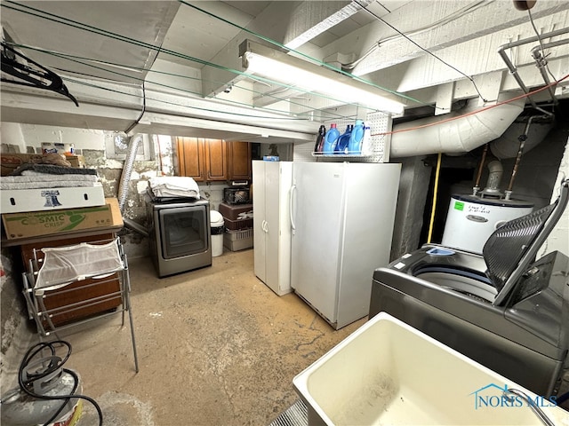 kitchen featuring gas water heater, brown cabinets, concrete flooring, and freestanding refrigerator