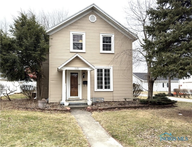 traditional-style home featuring a front yard