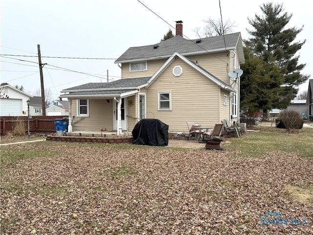 back of property featuring a patio area, fence, roof with shingles, and a chimney