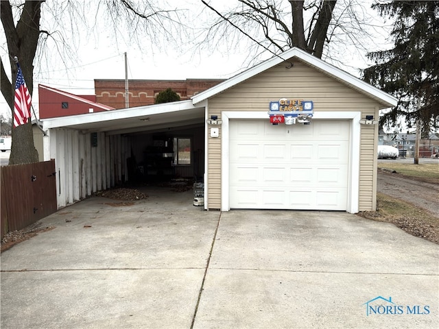 garage with an attached carport and driveway