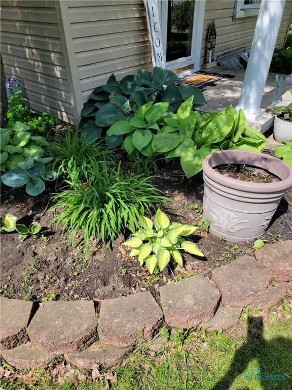 exterior details with a garden pond