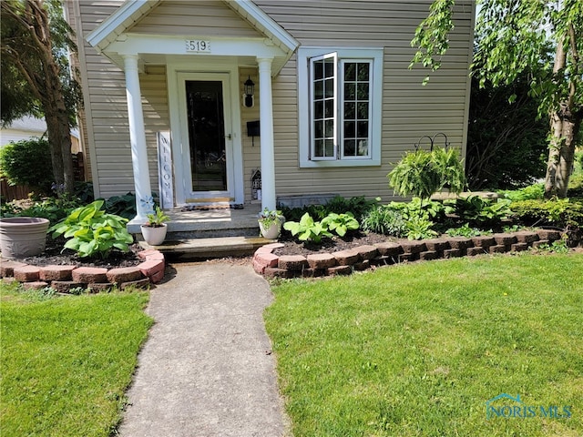 doorway to property featuring a lawn