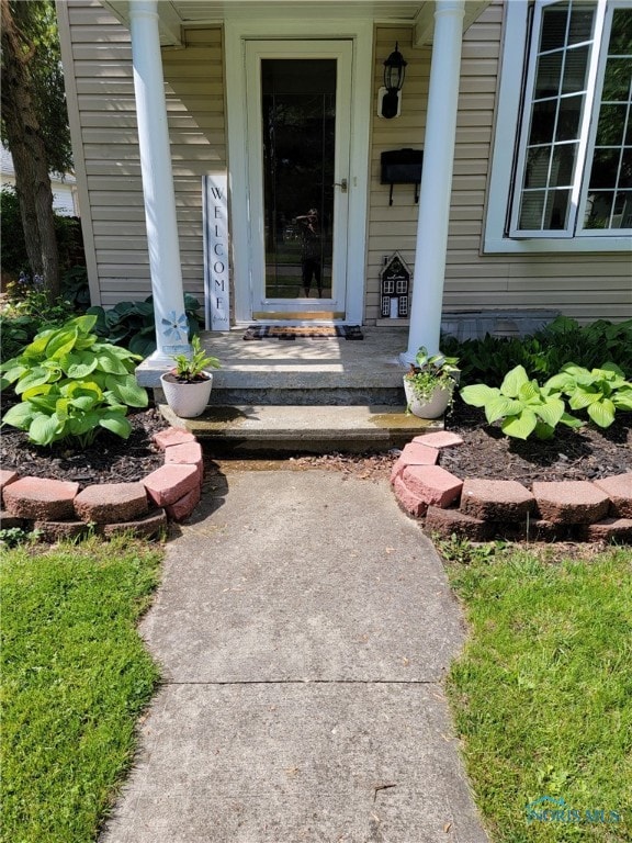 view of exterior entry with a porch